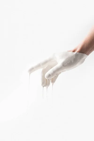 Imagem cortada de mulher em tinta branca apontando em algo isolado no branco — Fotografia de Stock