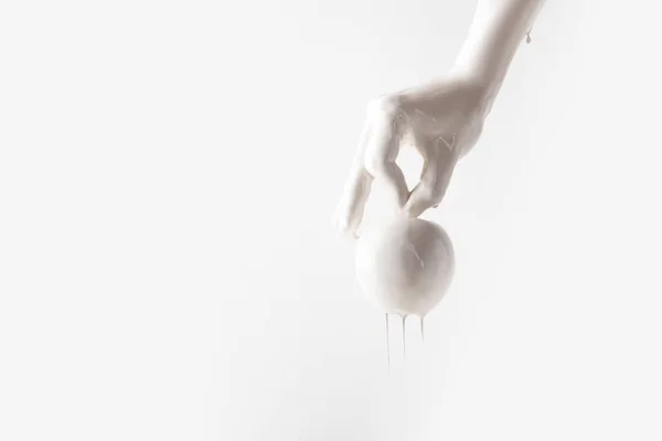 Cropped image of woman in white paint holding apple isolated on white — Stock Photo