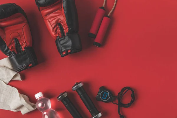 Flat lay composition of boxer training equipment on red tabletop — Stock Photo