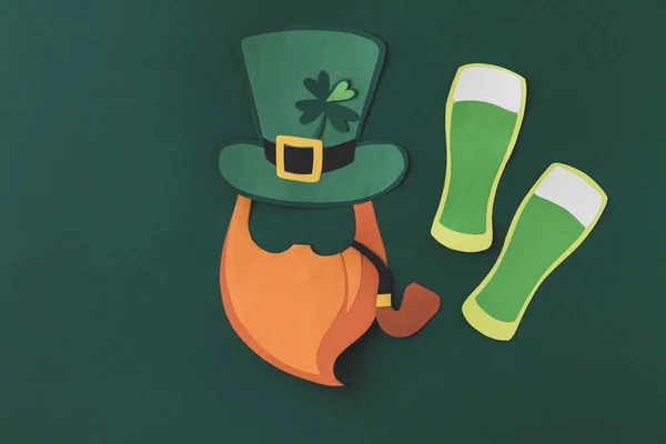 Top view of paper decoration of smoking leprechaun and beer for st patricks day isolated on green — Stock Photo