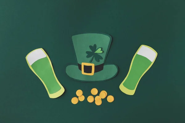 Top view of paper decoration of green hat and beer for st patricks day isolated on green — Stock Photo