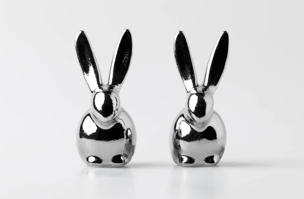 Two statuettes of easter rabbits on white — Stock Photo