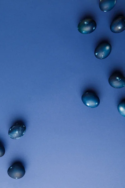 Верхний вид голубых окрашенных пасхальных яиц на голубой поверхности — стоковое фото