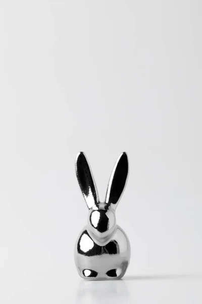 Silver statuette of easter bunny on white — Stock Photo