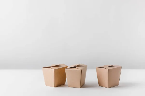 Three noodles boxes on white surface — Stock Photo