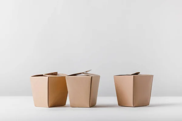 Three food containers on white surface — Stock Photo