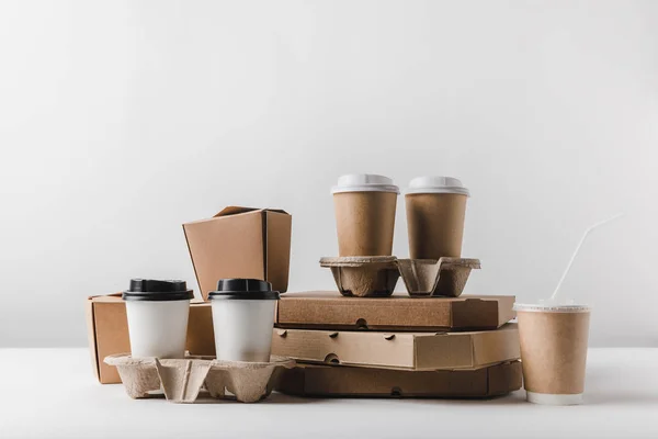 Pizza boxes and coffee to go with take away boxes on tabletop — Stock Photo