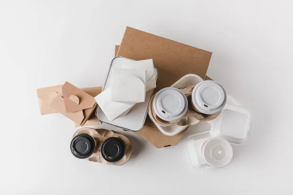 Top view of pizza boxes and disposable coffee cups with noodles boxes on white — Stock Photo