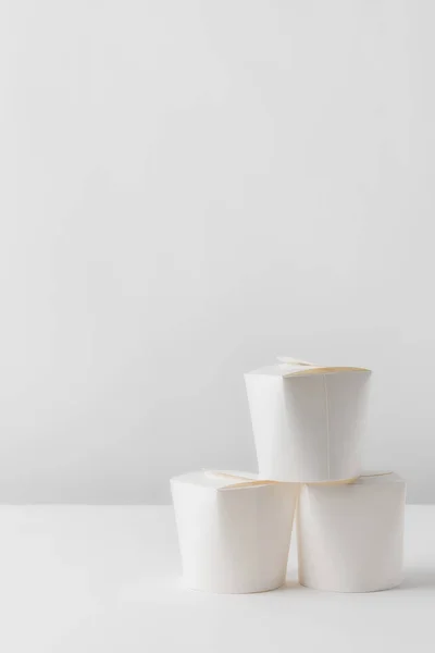 Three take away boxes on white table — Stock Photo