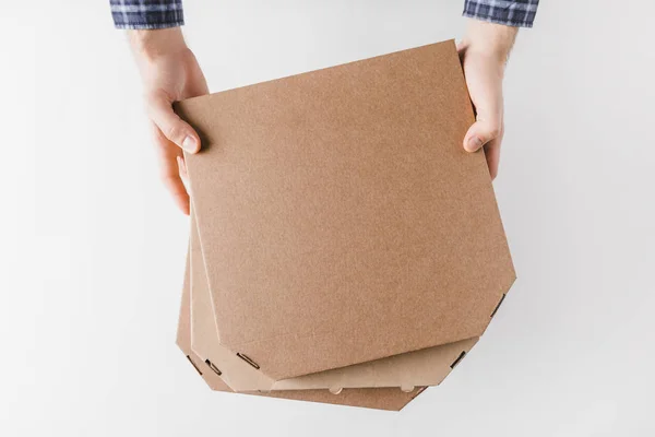 Imagem cortada de correio segurando caixas de pizza em mãos isoladas em branco — Fotografia de Stock