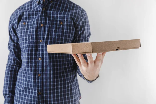 Cropped image of courier holding pizza box isolated on white — Stock Photo