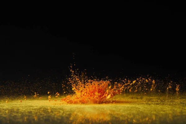 Yellow holi powder explosion on black, Hindu spring festival — Stock Photo