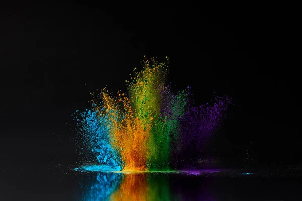 Colorful holi powder explosion on black, Hindu spring festival — Stock Photo