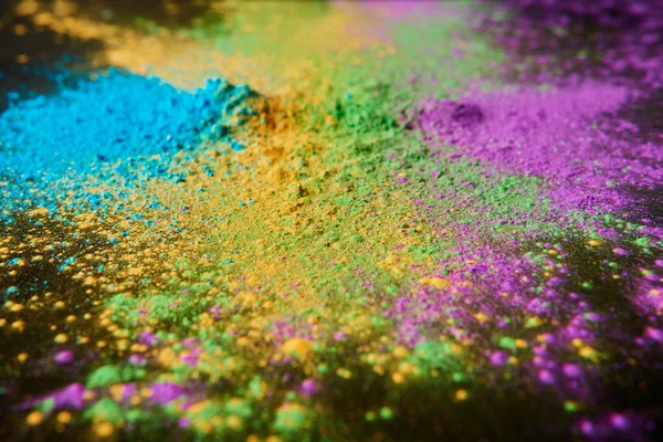 Colorful holi powder on black, traditional Indian festival of colours — Stock Photo