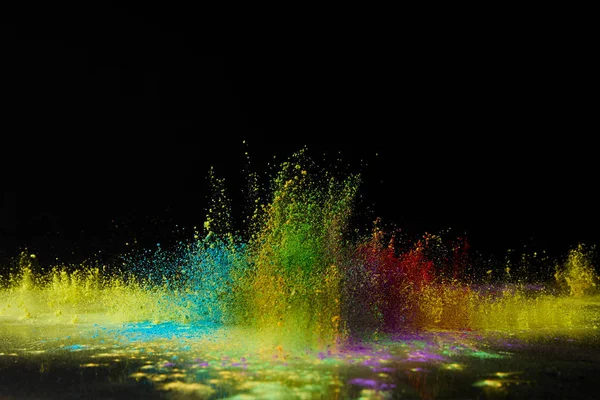 Colorful holi powder explosion on black, Hindu spring festival — Stock Photo