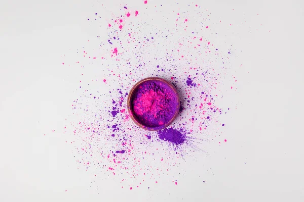 Top view of purple and pink holi powder in bowl isolated on white — Stock Photo
