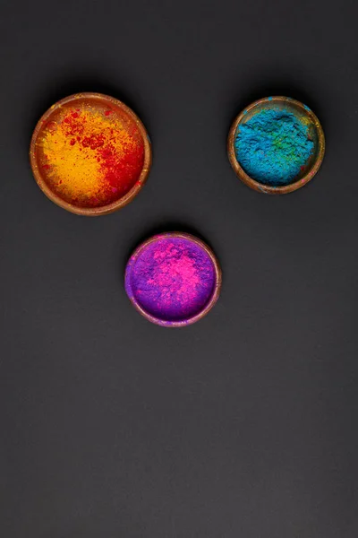Top view of traditional holi powder in bowls on grey surface, Hindu spring festival — Stock Photo