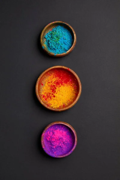 Top view of colorful holi powder in bowls in row on grey surface — Stock Photo