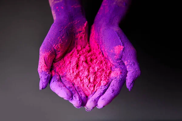 Vue recadrée des mains avec de la poudre holi violet et rose, isolée sur gris — Photo de stock