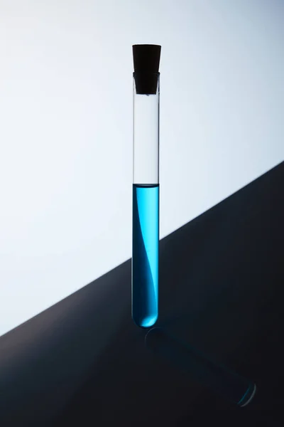 Single test tube filled with blue liquid — Stock Photo