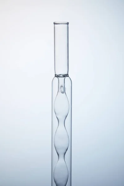 Close-up shot of empty chemistry flask on grey — Stock Photo
