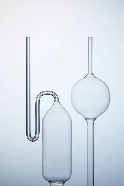 Various empty chemistry glassware on grey — Stock Photo