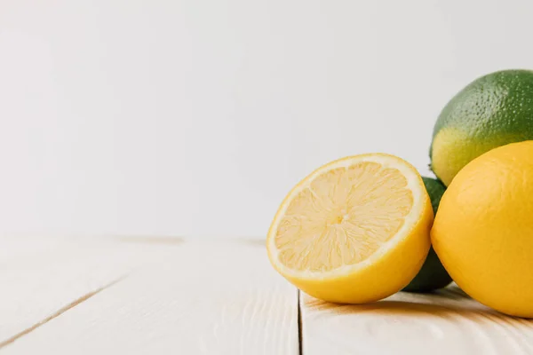 Ripe citrus fruits on white wooden background — Stock Photo