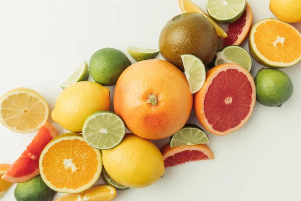 Pile of citruses whole and pieces isolated on white background — Stock Photo