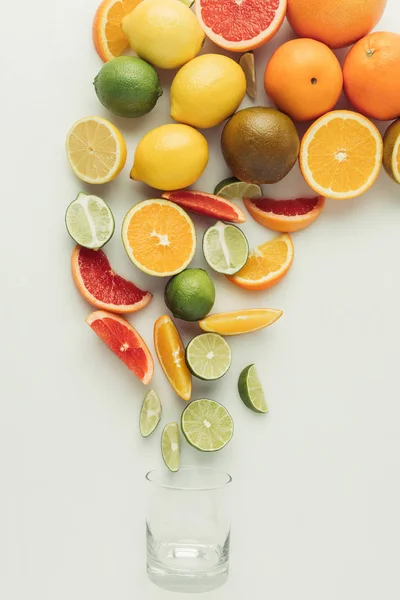 Heap of citrus fruits and glass isolated on white background — Stock Photo