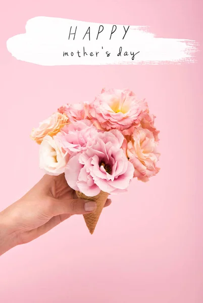 Cropped shot of person holding waffle cone with beautiful blooming flowers isolated on pink — Stock Photo