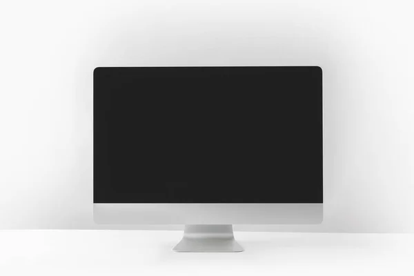 Modern desktop computer with black screen on white — Stock Photo