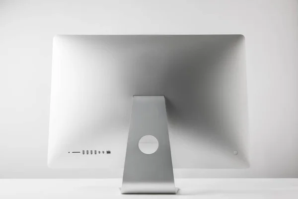 Back view of desktop computer monitor on white — Stock Photo