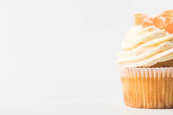 Close up view of sweet cupcake with cream and tangerine isolated on white — Stock Photo