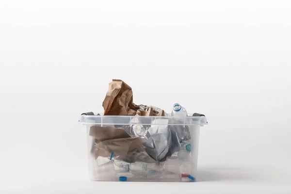 Primer plano vista de contenedor con papel y basura de plástico aislado en blanco, concepto de reciclaje - foto de stock