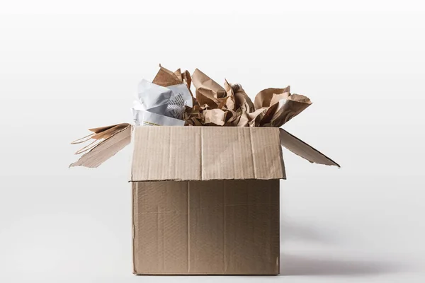 Close up view of cardboard box with papers inside isolated on white — Stock Photo