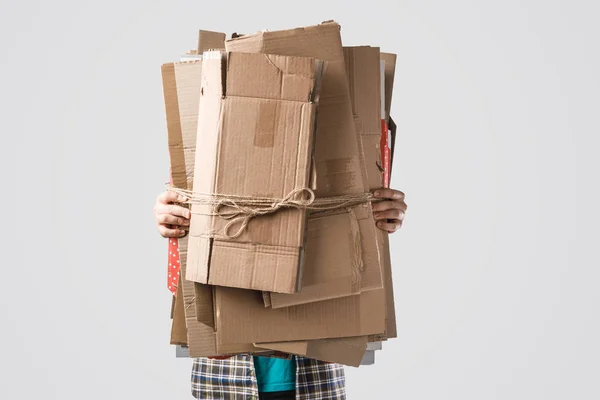 Abgeschnittene Aufnahme eines Mannes mit einem Stapel gefalteter Kartons isoliert auf grauem Papier, Recyclingkonzept — Stockfoto