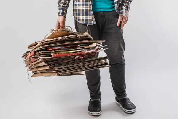 Cropped shot of man holding pile of folded cardboard boxes isolated on grey, recycling concept — Stock Photo