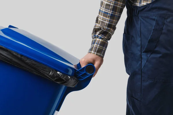 Partial view of cleaner with trash bin isolated on grey — Stock Photo