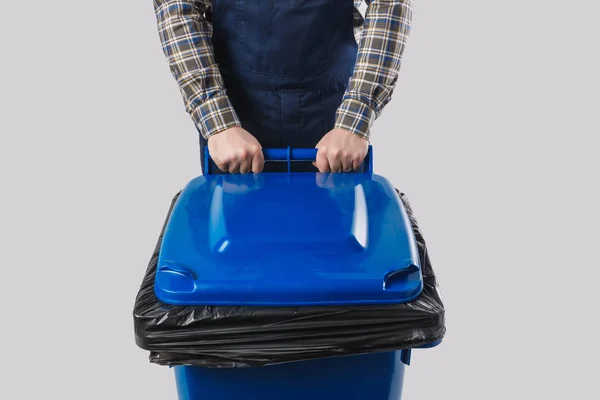 Partial view of cleaner with trash bin isolated on grey — Stock Photo