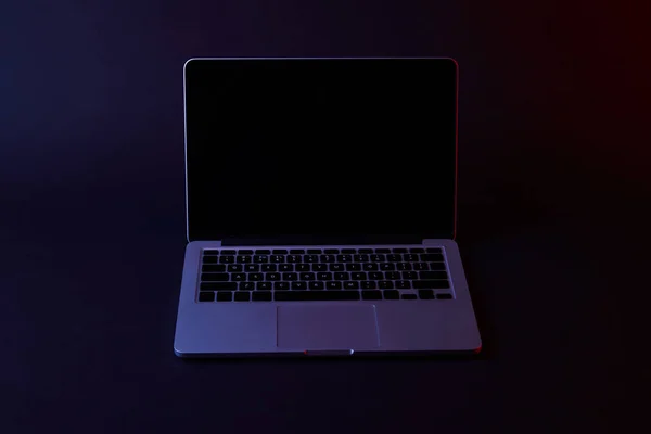 One turned off laptop with blank screen on dark — Stock Photo