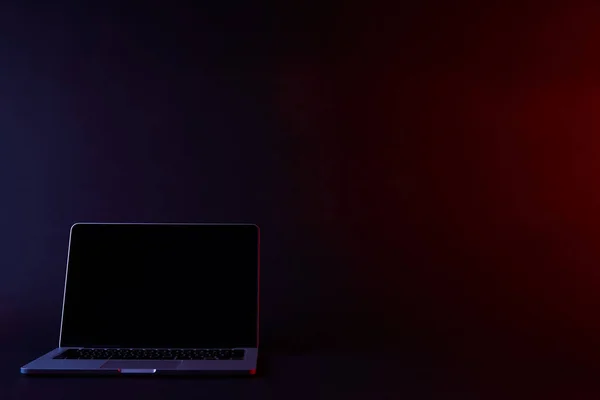 Turned off laptop with blank screen on dark — Stock Photo