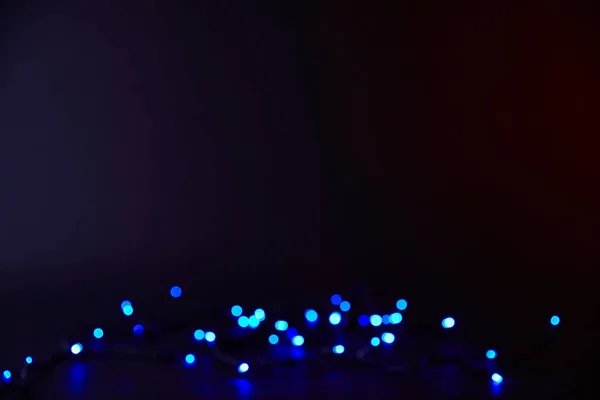 Abstract dark background with blue bokeh — Stock Photo