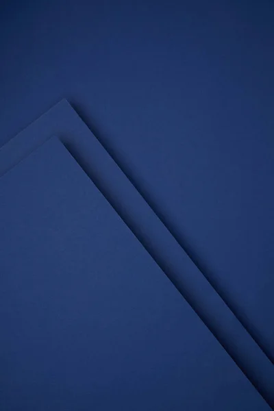 Dark abstract background made from blue colored paper — Stock Photo