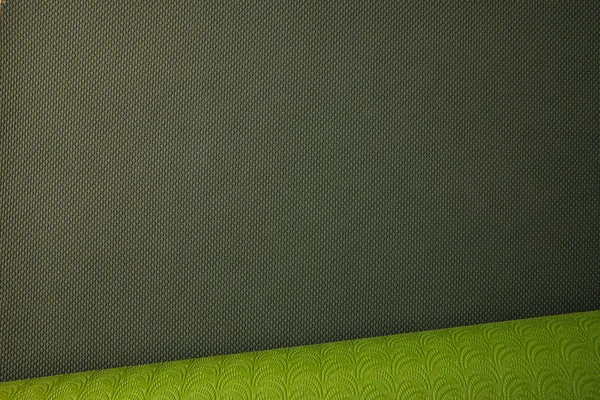 Top view of green rolled yoga mat — Stock Photo