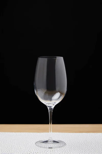 Empty wine glass on table on black background — Stock Photo