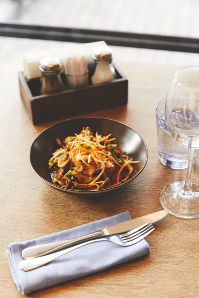 Hot delicious udon noodles with pork on restaurant table — Stock Photo