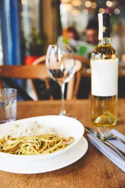 Italian pasta with mushrooms and cheese served with wine — Stock Photo
