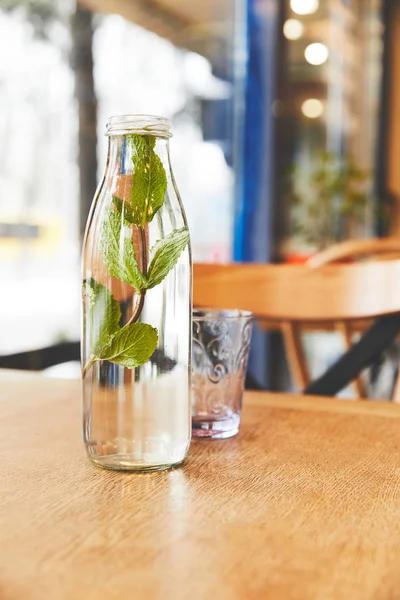 Ajuste de mesa con vidrio y agua de menta - foto de stock