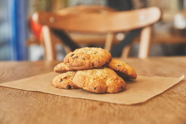 Homemade chocolate chip cookies on craft paper — Stock Photo