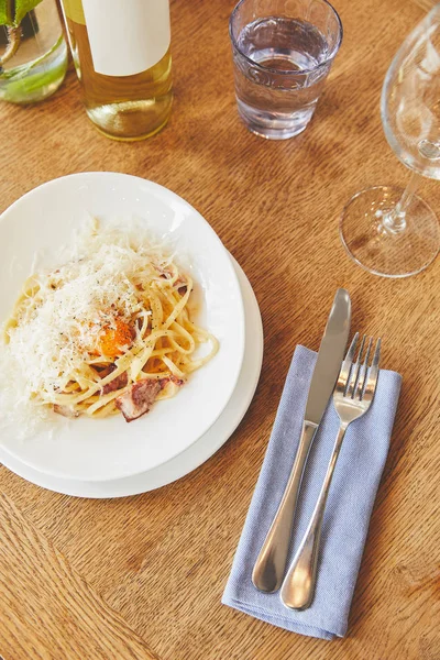 Italian carbonara pasta served with wine — Stock Photo